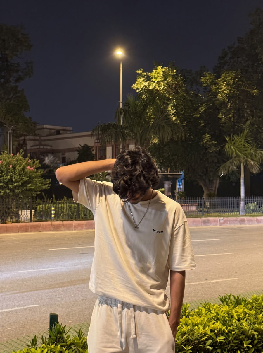 Off-white oversized t-shirt worn on a tree-lined street at night
