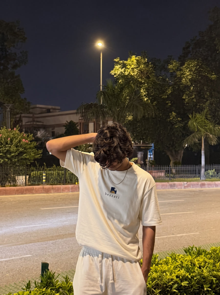 Off-white oversized t-shirt worn on a tree-lined street at night
