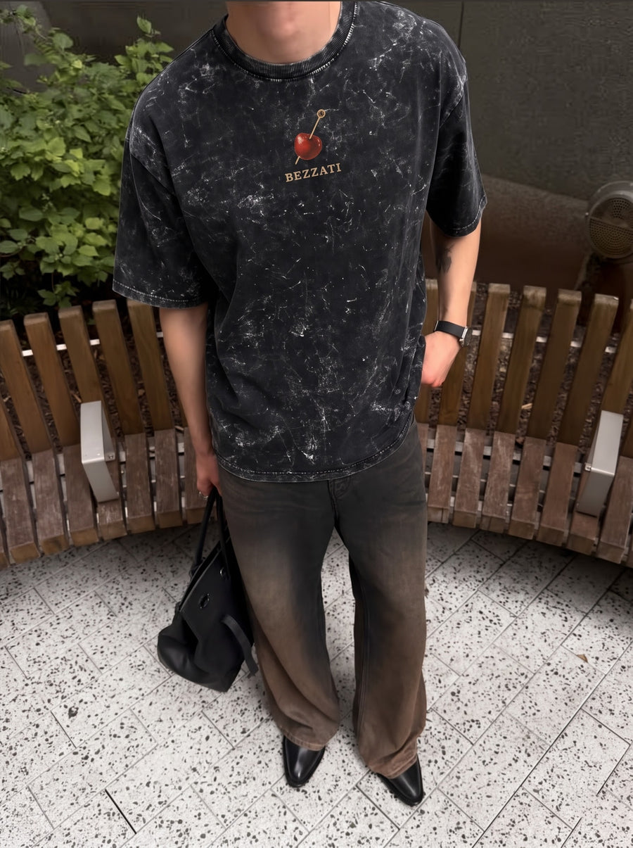 Front of the black acid-wash t-shirt, with a small cherry above the Bezzati wordmark