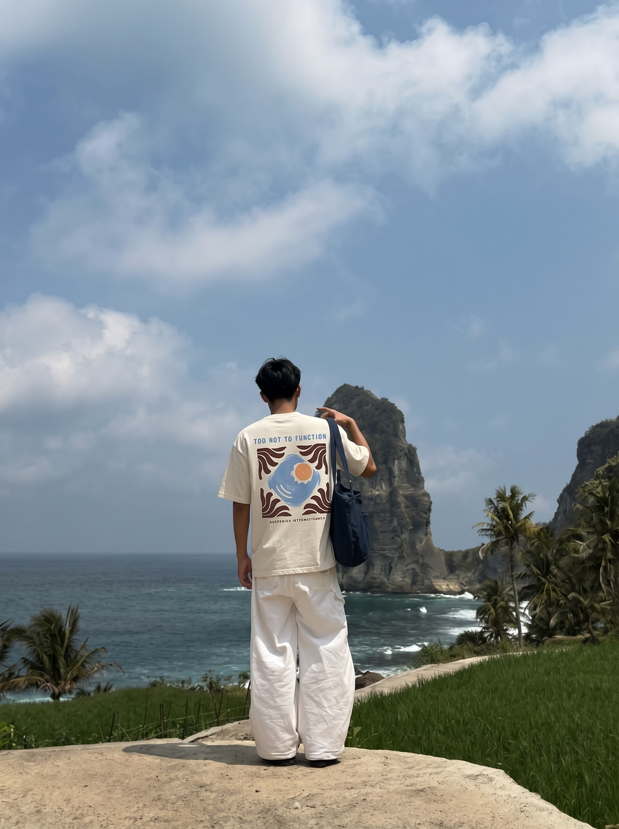 Too Hot To Function back print, a sun set in a tiled square, worn on a cliff above the sea