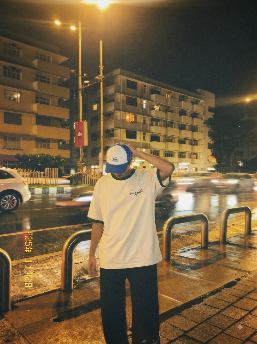 Cream Bezzati ringer t-shirt worn on a wet city street at night under a streetlight