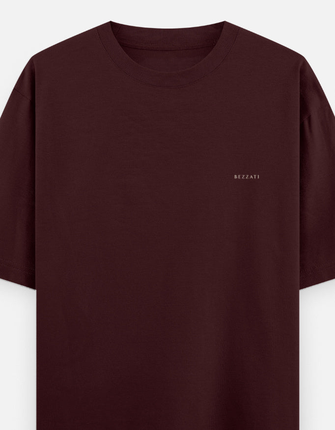 Front of the maroon Aap Zara oversized t-shirt, plain with a small BEZZATI wordmark on the left chest