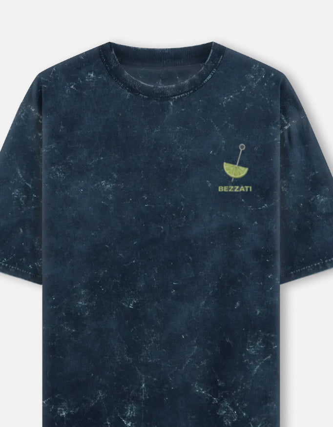 Front of the navy acid-wash oversized t-shirt, with a small lime wedge above the Bezzati wordmark on the chest