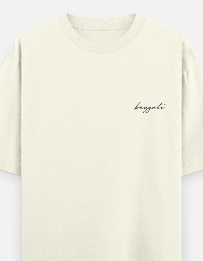 Front of the off white Pehle regret phir cigarette oversized t-shirt, plain with dropped shoulders and a small bezzati script