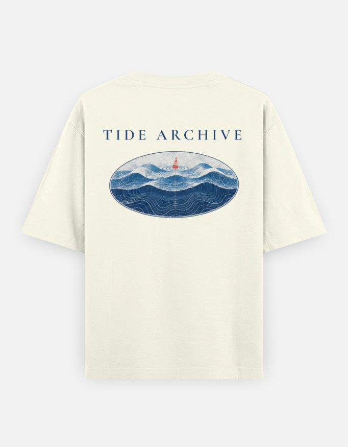 Tide Archive back print: rolling waves and a small lighthouse framed in an oval, on an off-white oversized t-shirt