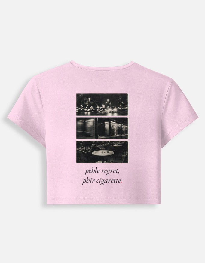 Pehle Regret Phir Cigarette baby tee in light baby pink, back print of a black and white night-photo triptych above the line in italic serif
