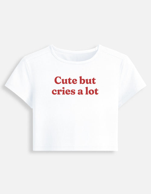 Front of the white Cute But Cries a Lot cropped baby tee: Cute but cries a lot in red serif